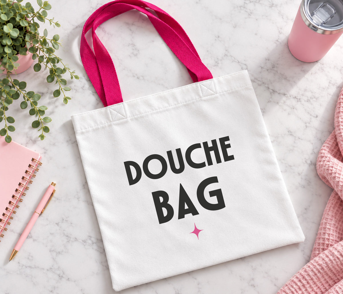 White tote bag with bright pink handles. Large black text saying 'douche bag' and our pink sparkle.