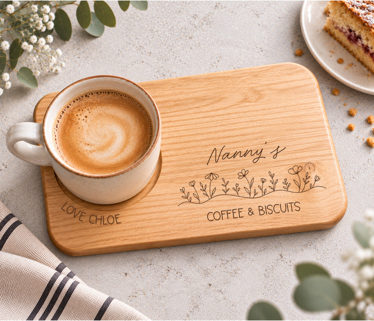 A rectangular wooden serving tray engraved with 'Nanny's coffee & BISCUITS' and a line of wildflowers, with love and the child / childrens name wrapped around the mug indent.