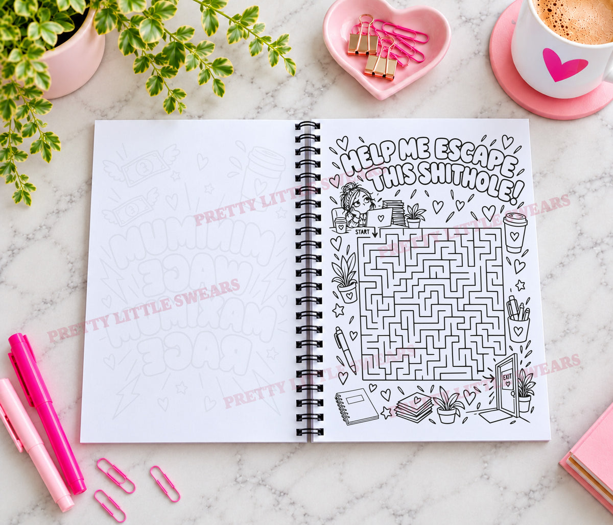An open spiral-bound notebook on a marble surface, featuring a school-themed maze and the text 'HELP ME ESCAPE THIS shithole!' on one page. The notebook is surrounded by pink stationery, a plant, a coffee cup, and binder clips.