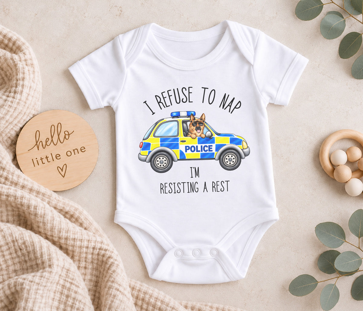 Baby vest with a cartoon police car with a police dog handing out the window and the wording 'I refuse to nap, i'm resisting arrest'