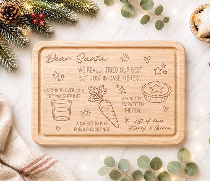 A funny Christmas Eve board for Santa's treats. With the message 'Dear Santa we really tried our best, but just in case, here's...'  A drink to overlook the naughty bits, a carrot to buy rudolph's silence and a mince pie to sweeten the deal. With love the childrens names.