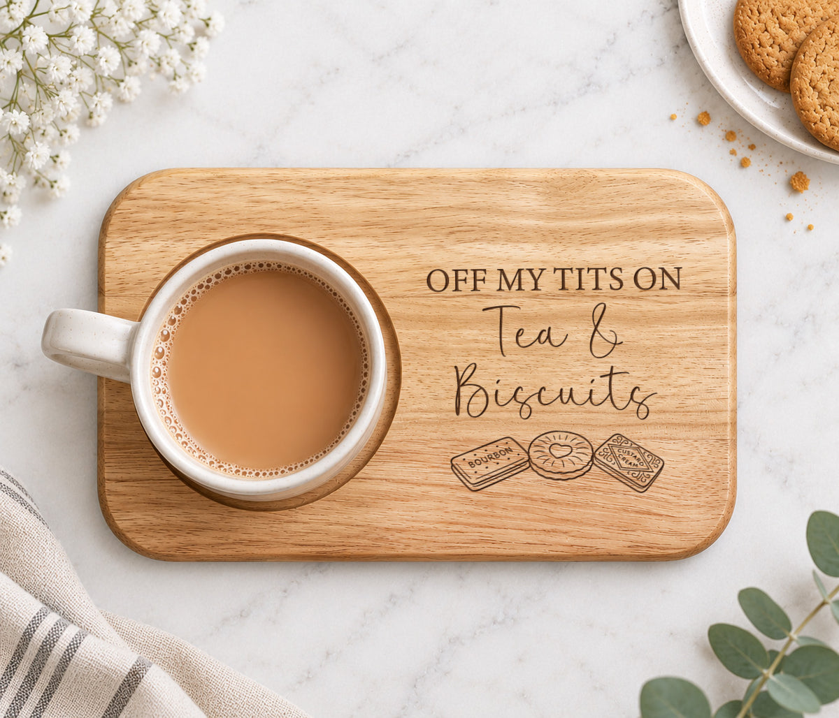 Wooden tea and biscuits board engraved with funny Off My Tits On Tea & Biscuits wording, featuring a mug of tea in a recessed cup holder.