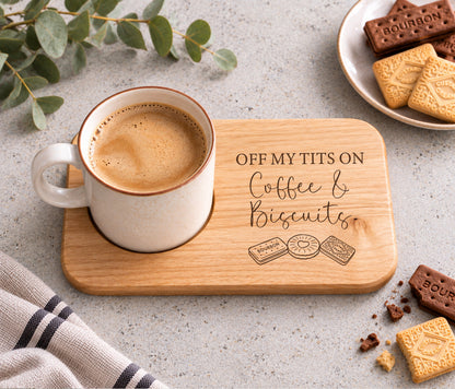 Wooden coffee and biscuits board engraved with funny Off My Tits On Coffee & Biscuits wording, featuring a mug of coffee in a recessed cup holder.